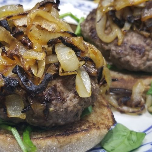 Beef hamburger with caramelized onions, arugula, spinach, whole wheat english muffin