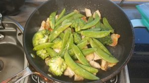 Fresh vegetables snap peas and brocolli in a stir fry