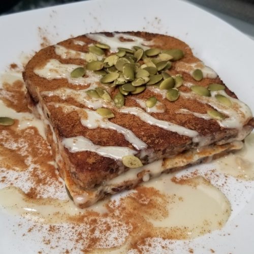 Protein French Toast with protein glaze, cinnamon, and pepitas