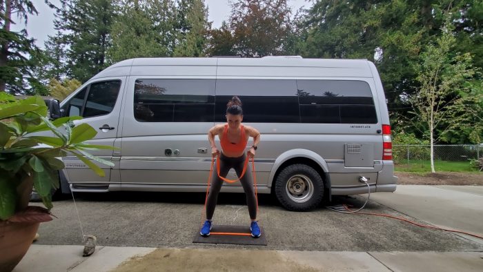 Outdoor workout using resistance bands during vanlife