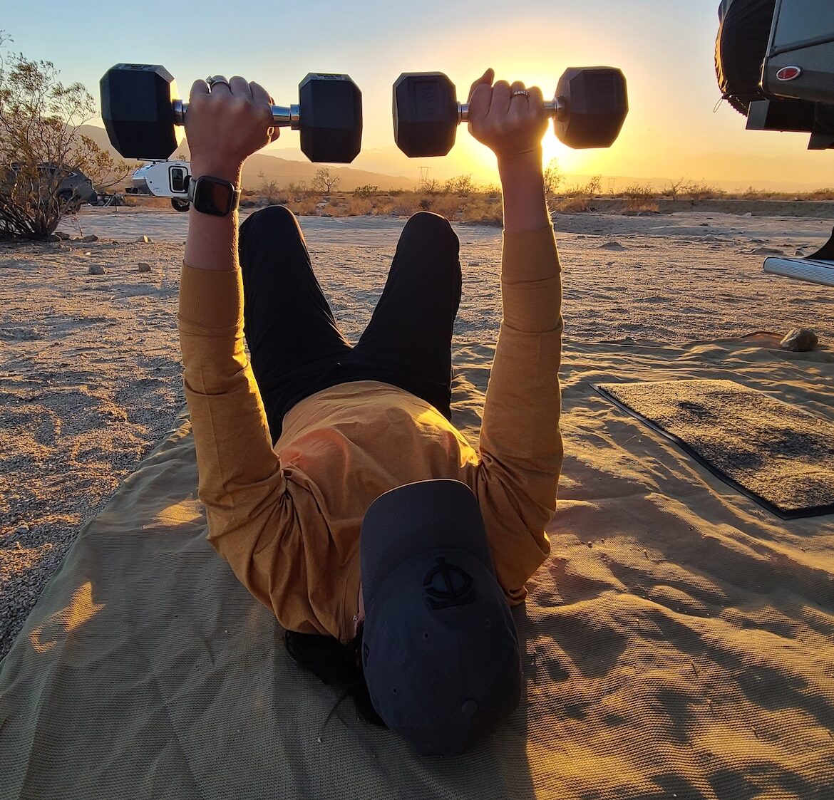 Women lifting weights outside RV