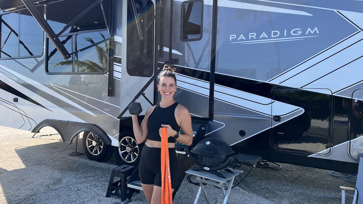 Strong woman holding strength training equipment